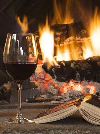 Red wine and an open book on the hearth