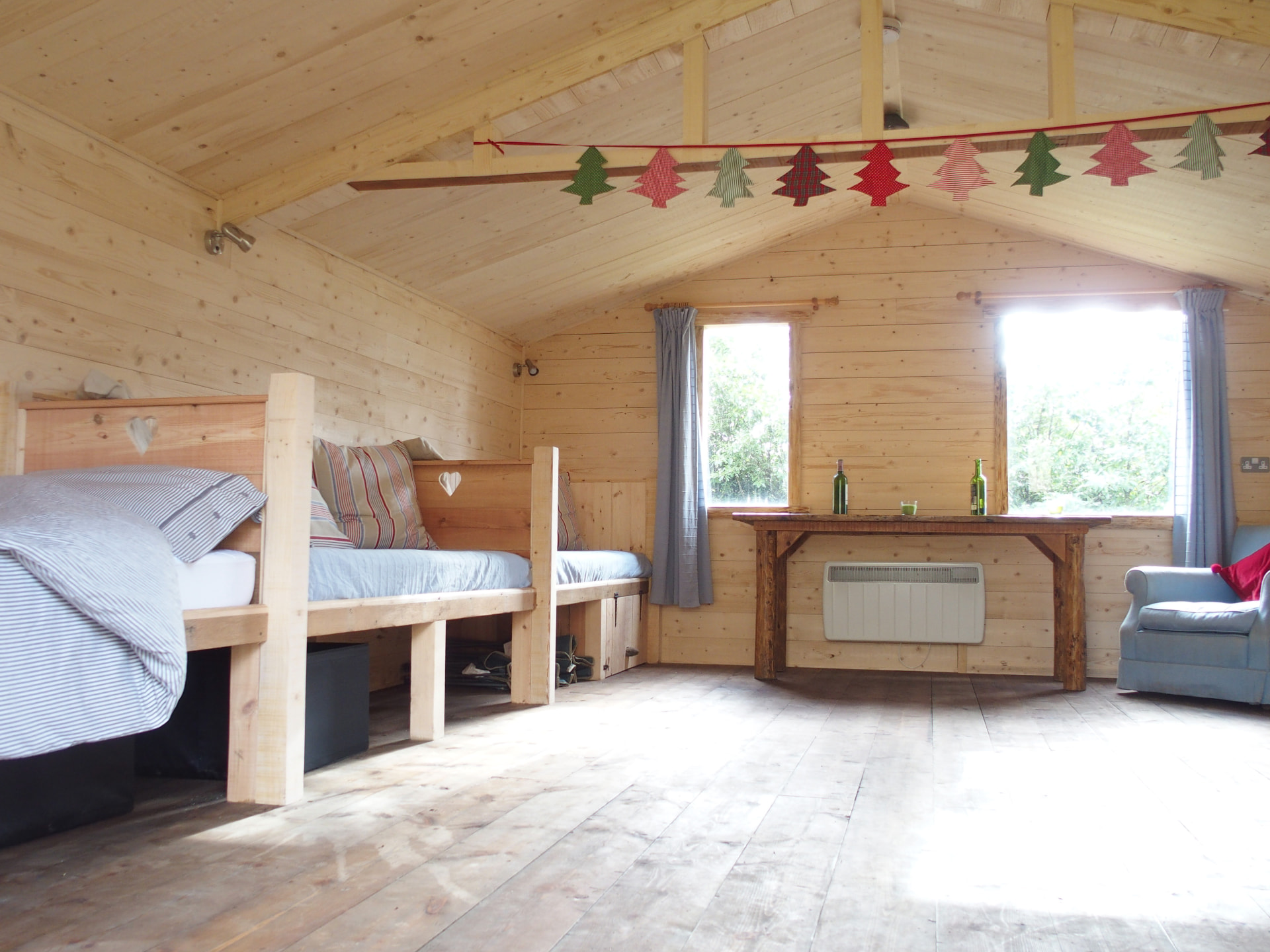 Beds and an armchair inside the Den, decorated for Christmas