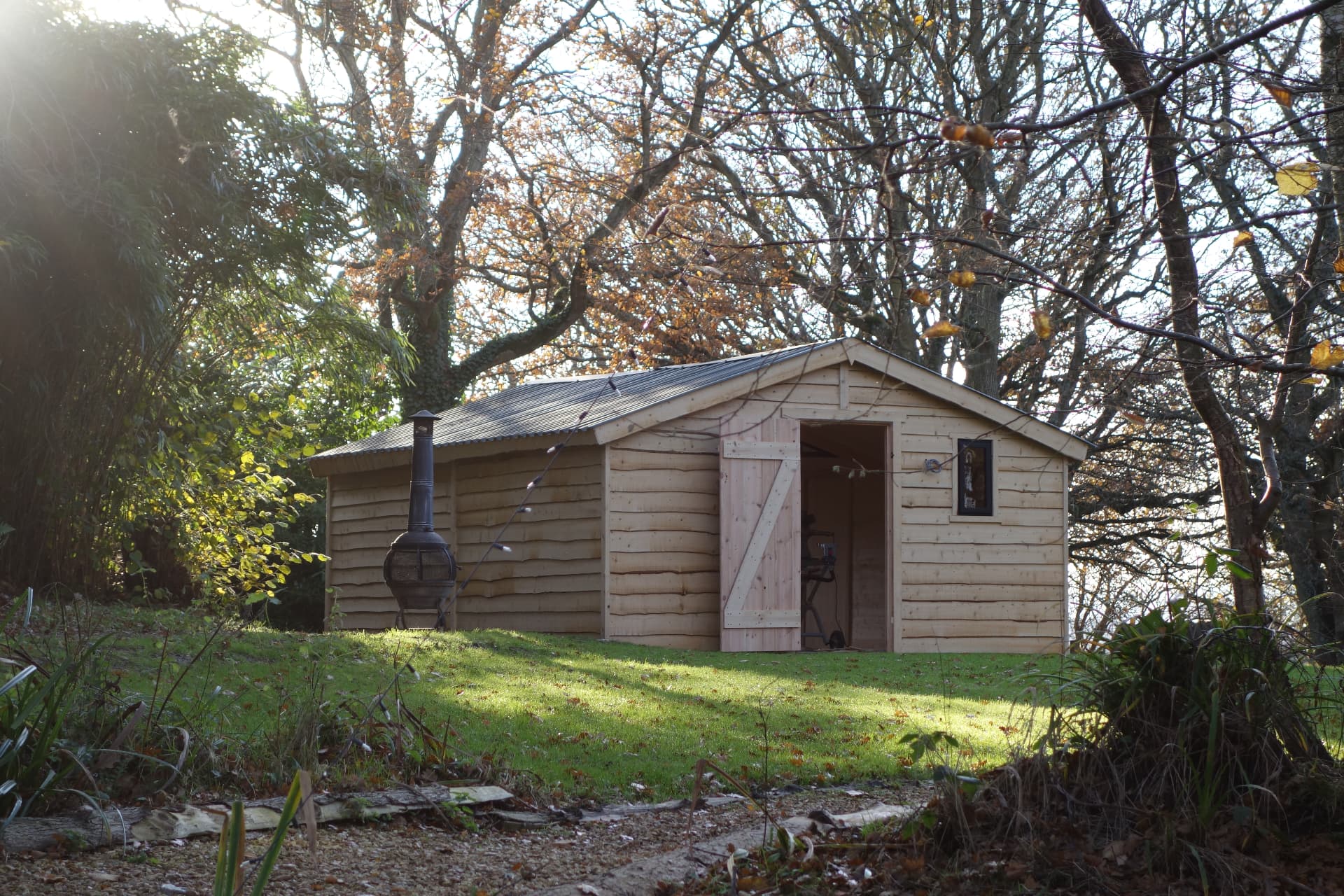 The Den games room from outside, with its firebowl beside the open door